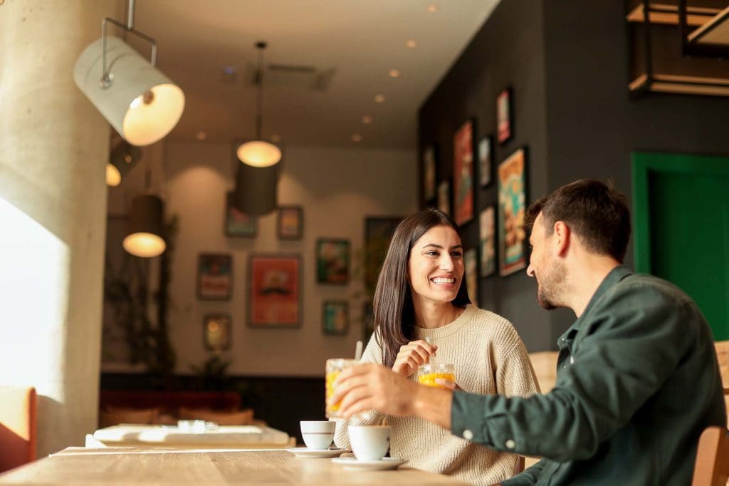 Couple shares a joyful moment at a stylish café